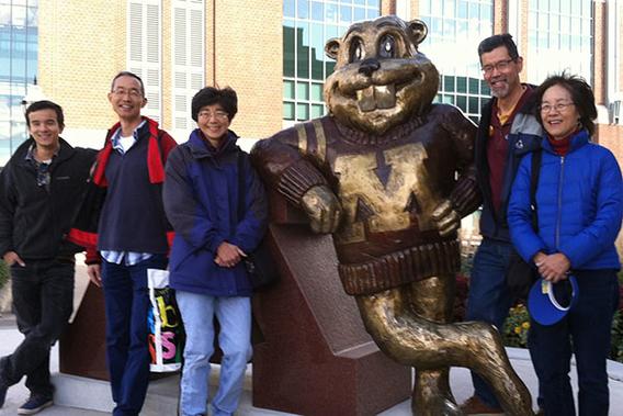 Members of Toni's family who are U of M grads and Toni in front of Goldy statue