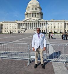 David Kabuye standing in front of capitol