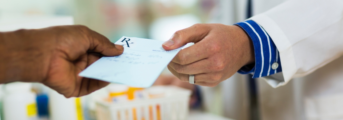 passing prescription paper to the pharmacist