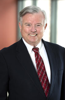 Jim Cloyd in a dark suit with red tie