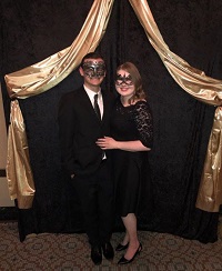 two people in masquerade outfits