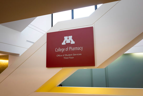 College of Pharmacy sign on staircase in Weaver Densford Hall