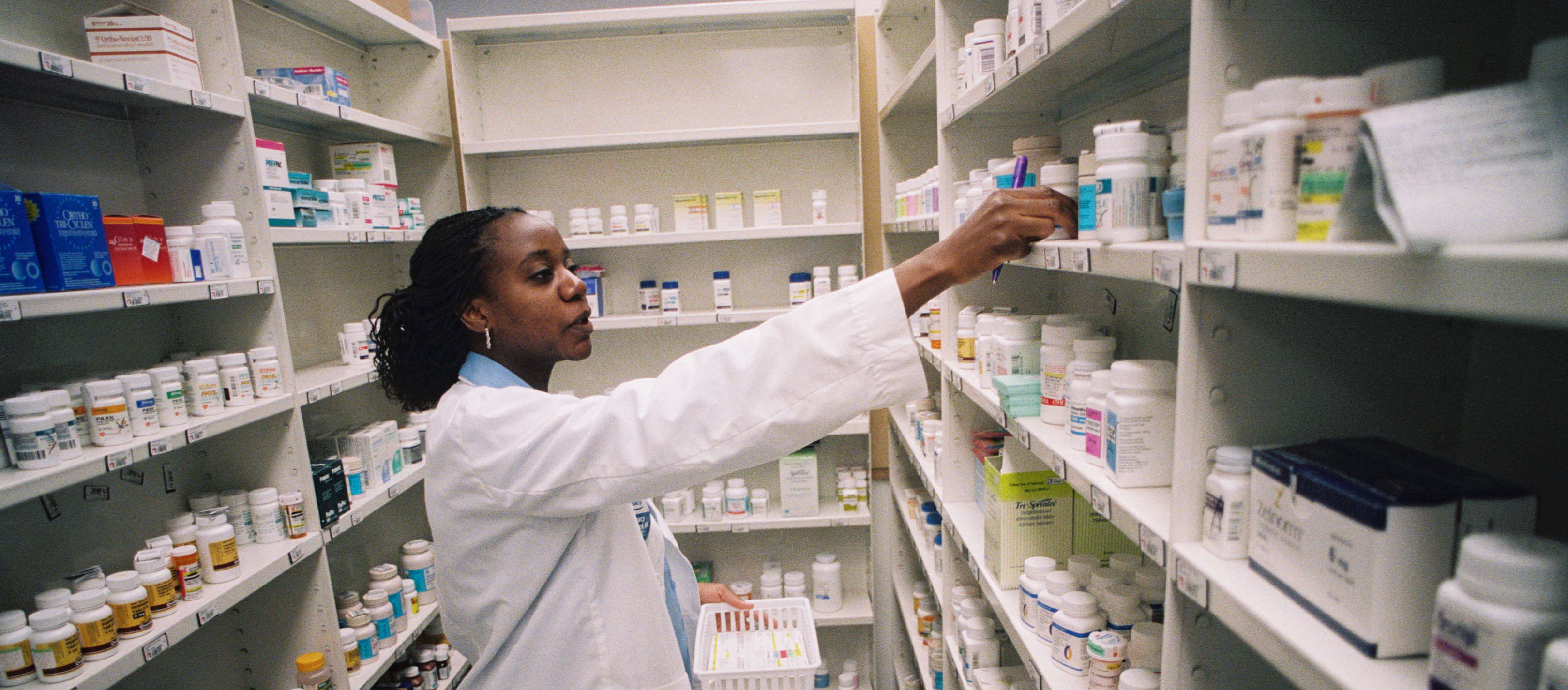 Pharmacist shelving medication