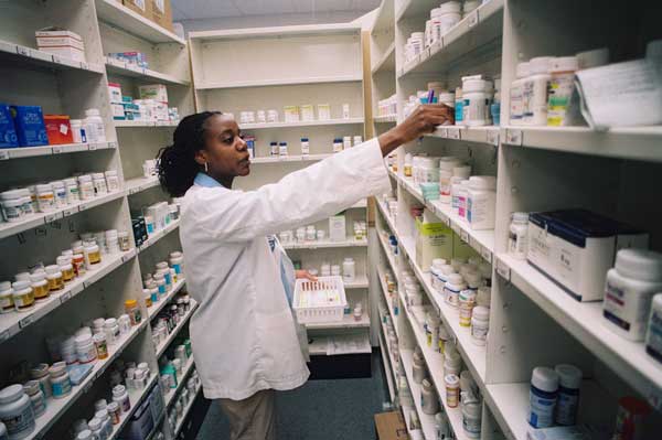 Pharmacist shelving medication