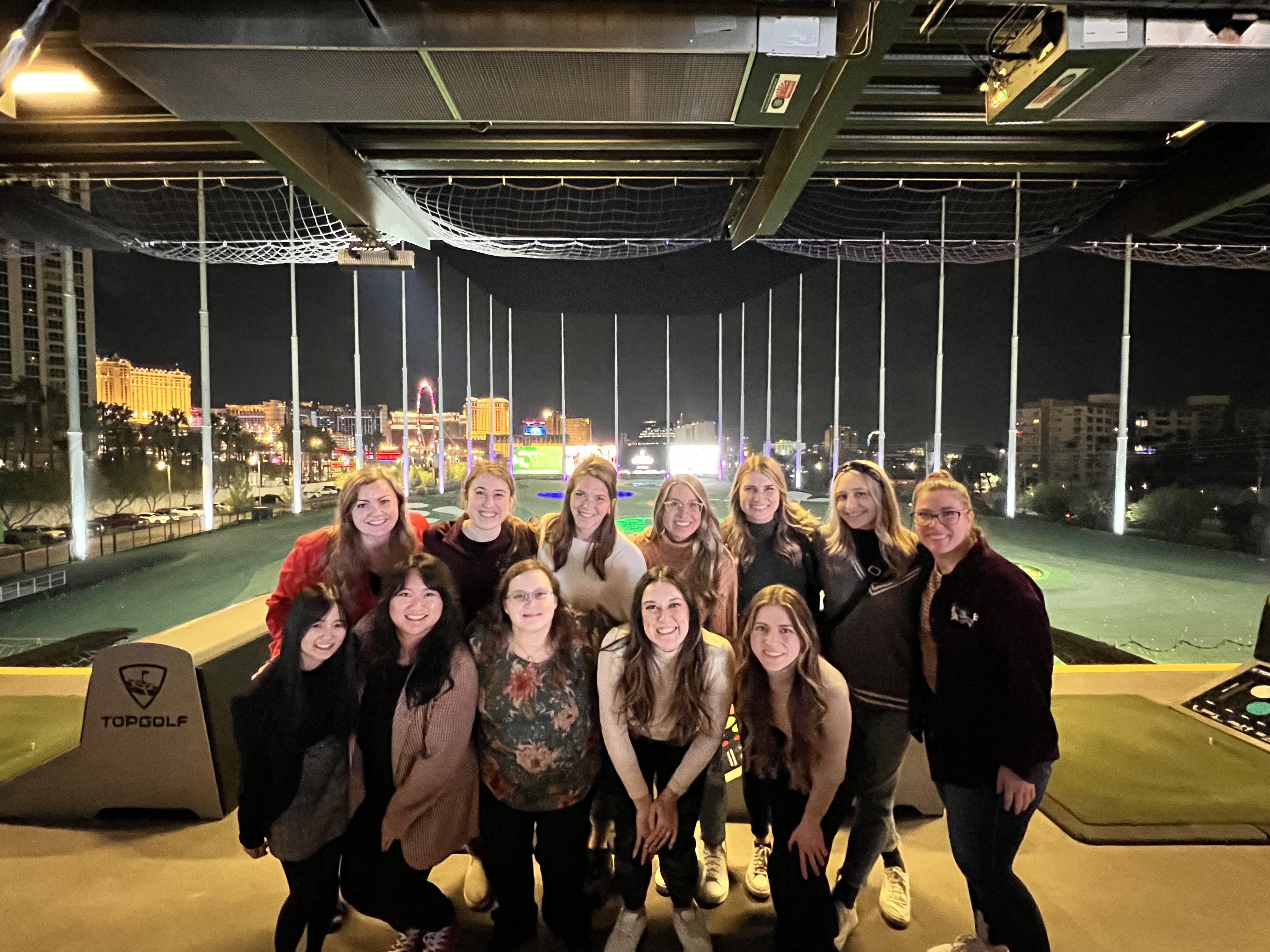Residents pose at TopGolf.
