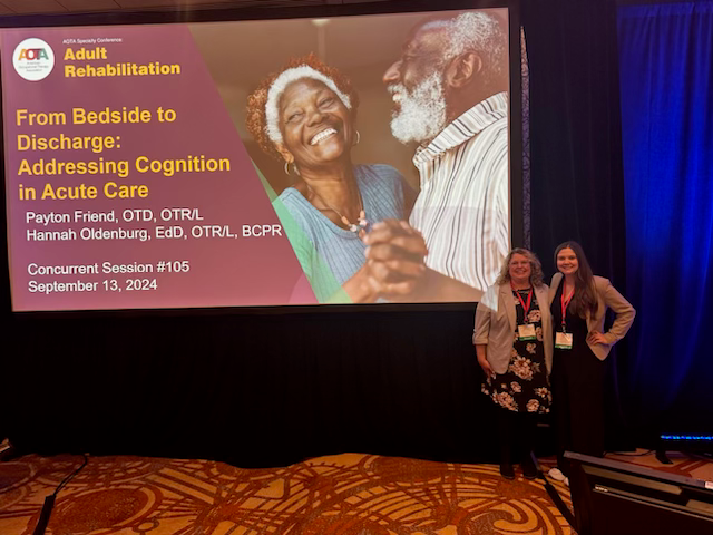 hannah and payton standing next to presentation screen
