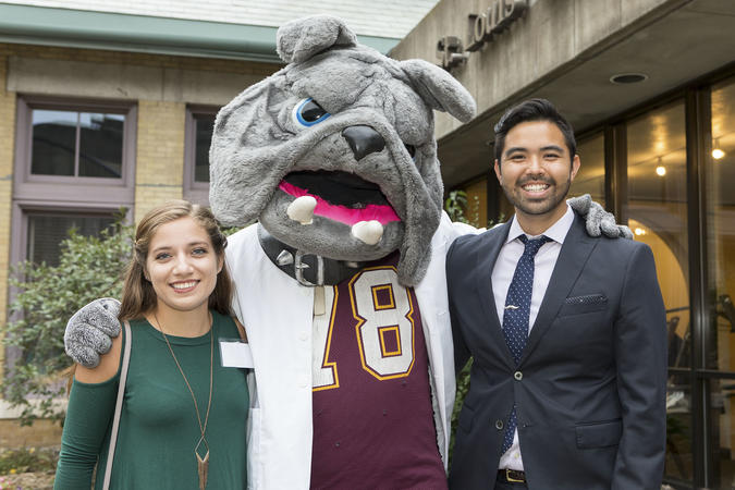 College of Pharmacy alumni posing for a photo with the University of Minnesota Duluth campus mascot