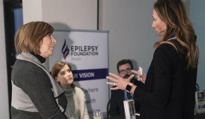 Attendees interacting with representatives from the Epilepsy Foundation of Minnesota.